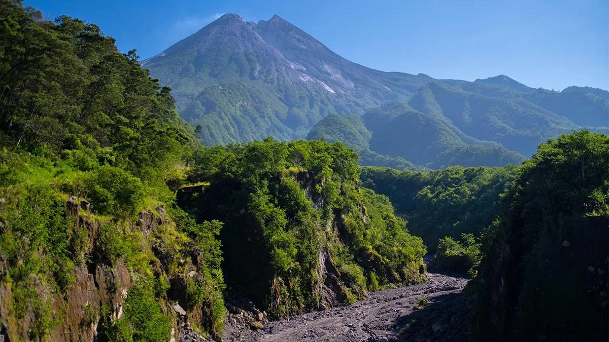 Mount Merapi above a green river valley